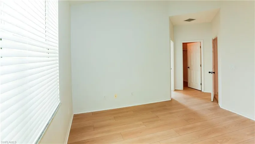 Unfurnished room featuring baseboards and wood finished floors