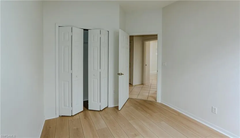 Unfurnished bedroom with light wood finished floors and a closet