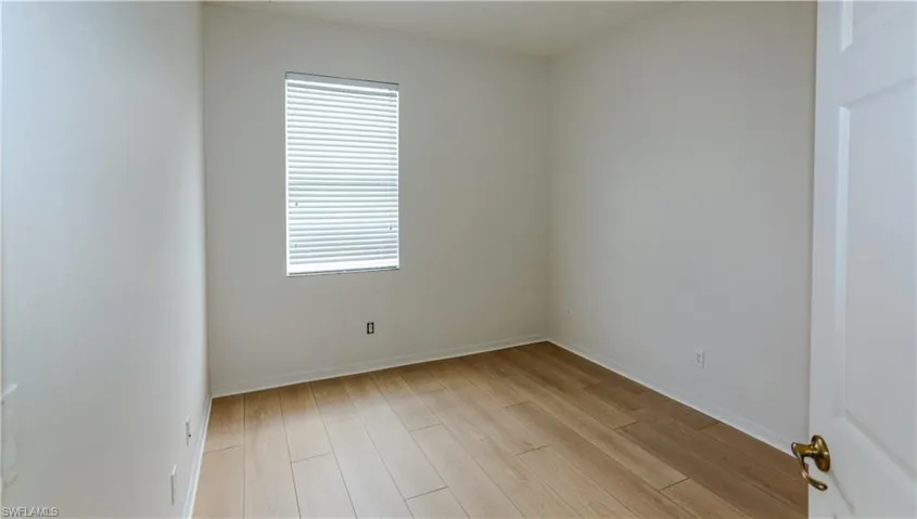 Spare room with light wood-style flooring and baseboards