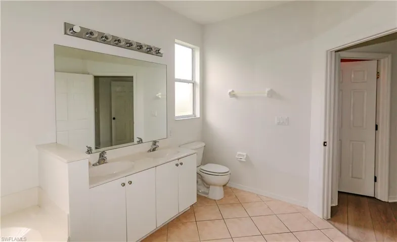 Bathroom featuring light tile patterned floors and a garden tub