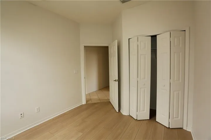 Unfurnished bedroom featuring light wood-style flooring and a closet