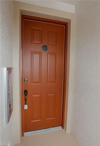 Entrance to property featuring stucco siding