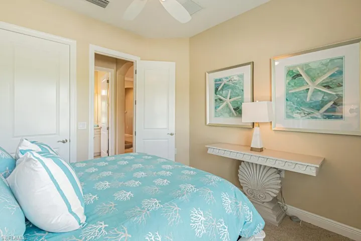 Carpeted bedroom with ceiling fan
