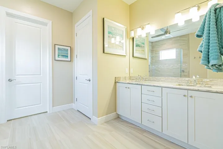 Bathroom featuring double vanity and tile patterned flooring