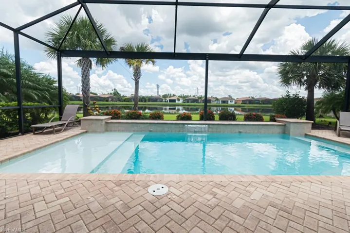 View of swimming pool featuring a lanai