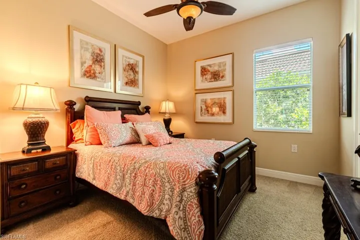 Carpeted bedroom with ceiling fan