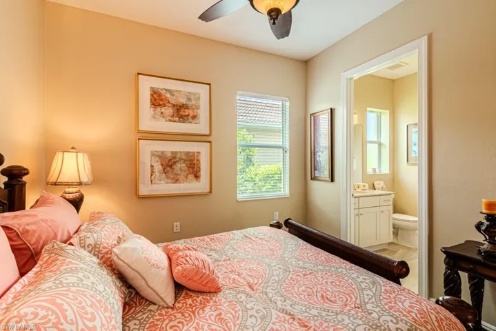 Bedroom with ceiling fan and ensuite bath
