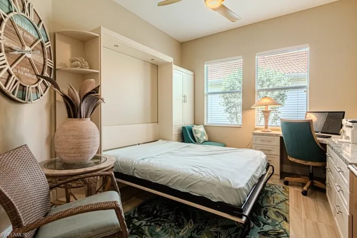 Bedroom featuring ceiling fan and light hardwood / wood-style flooring