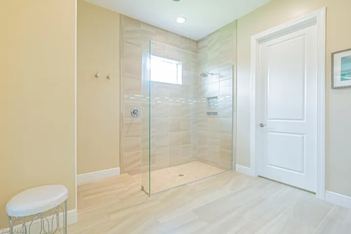Bathroom featuring tile patterned floors and tiled shower