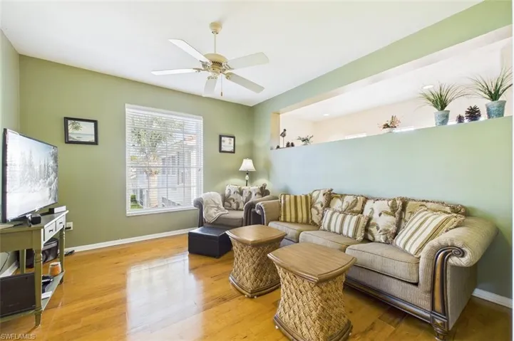 Living room featuring hardwood / wood-style floors and a ceiling fan