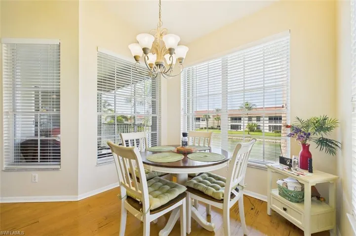 Dining space with light wood-style floors and a chandelier