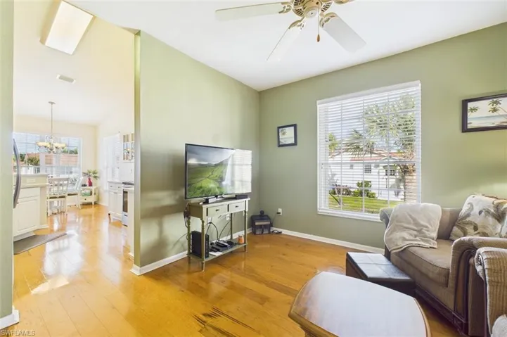 Living area featuring light wood-type flooring and ceiling fan