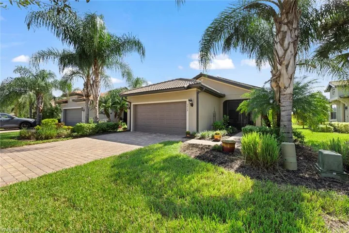 View of front of home featuring a garage and a front yard