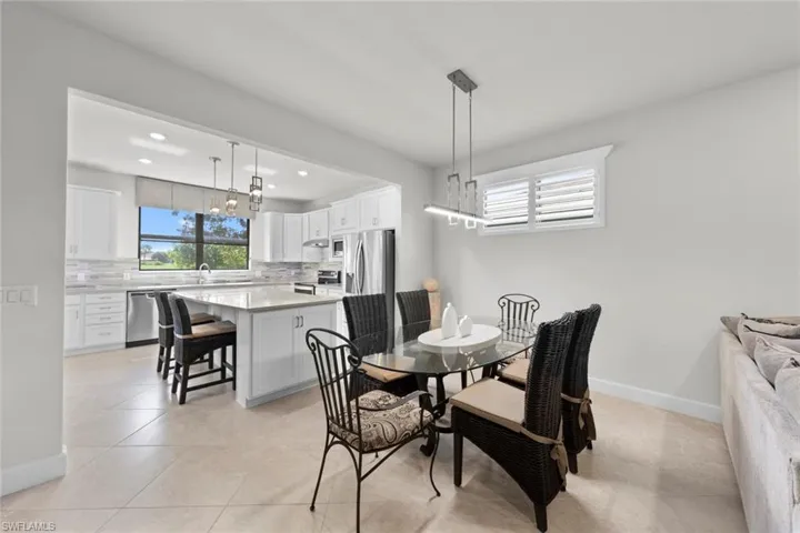 Tiled dining space featuring sink