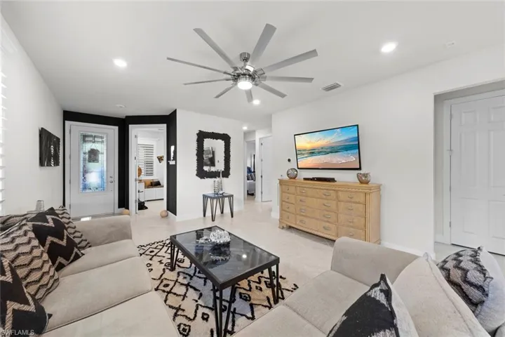 Tiled living room featuring ceiling fan