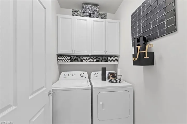 Laundry room featuring cabinets and independent washer and dryer