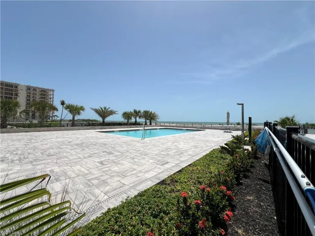 New Community pool with a patio area and a water view