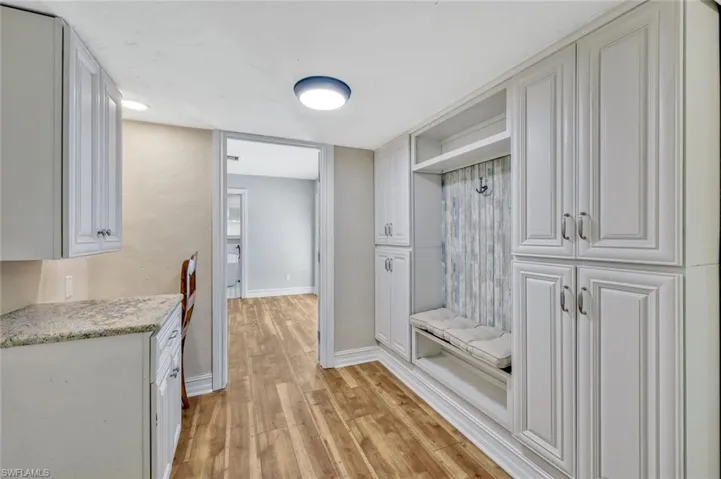 Mudroom with baseboards and light wood-type flooring