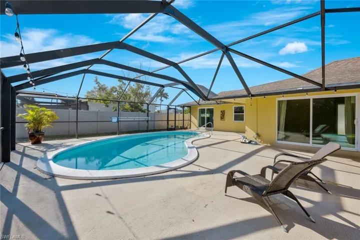 View of swimming pool featuring a lanai, fence, a patio, and a fenced in pool