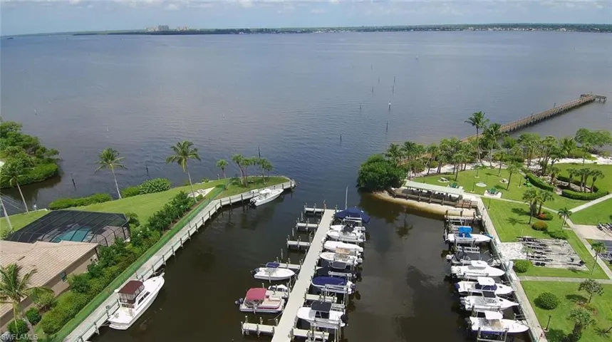Drone / aerial view with a water view and marina