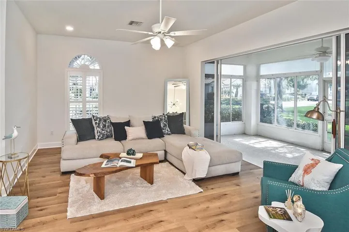 Living room featuring light wood-type flooring and ceiling fan