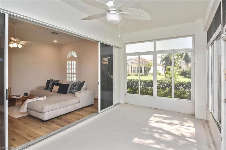 Sunroom / solarium with ceiling fan looking into the home