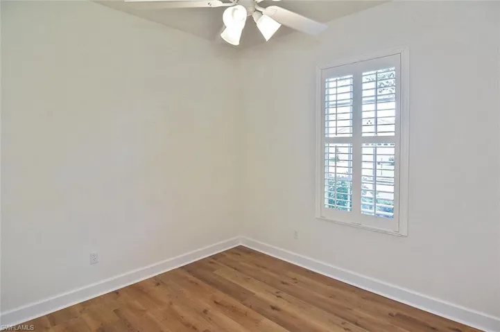 bedroom 3 with hardwood / wood-style flooring and ceiling fan