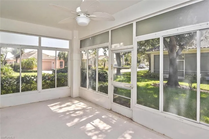 Unfurnished sunroom with ceiling fan
