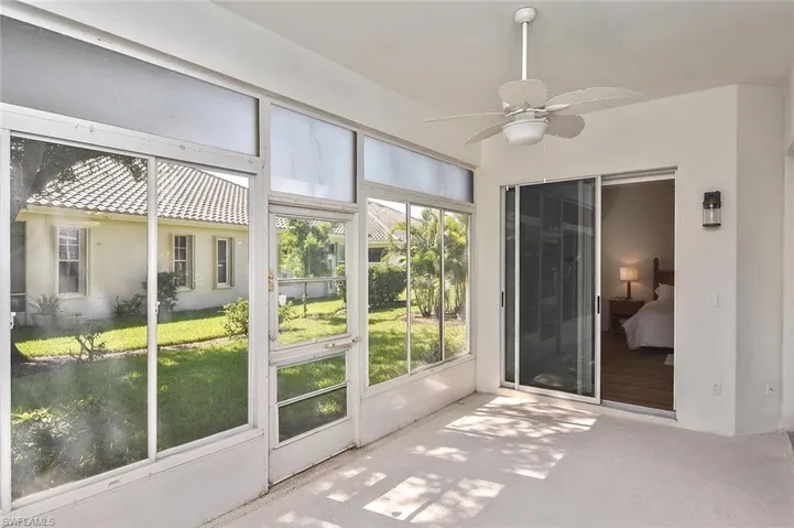Unfurnished sunroom with ceiling fan
