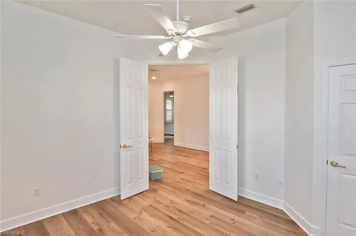 Bedroom 2 with light hardwood wood-style floors and ceiling fan