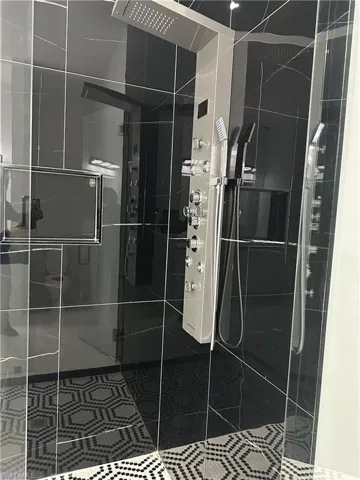 Full bath featuring a shower stall