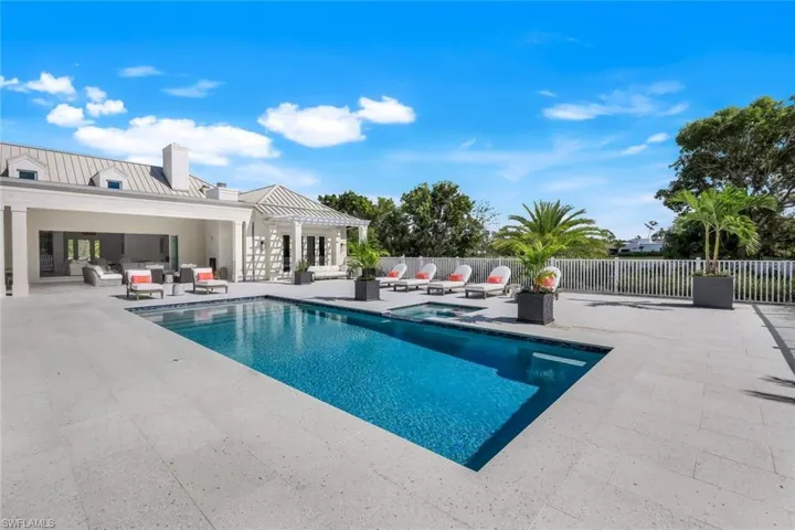 View of pool featuring outdoor lounge area, a patio area, and an in-ground hot tub