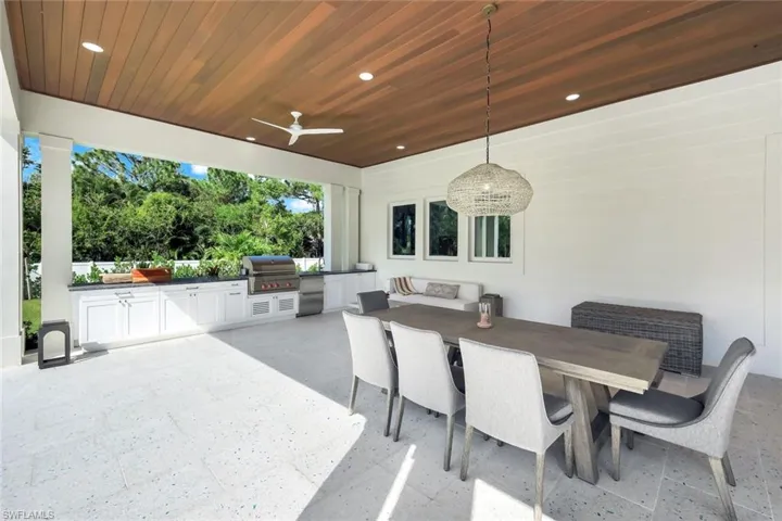 View of patio with outdoor dining space, an outdoor kitchen, and ceiling fan