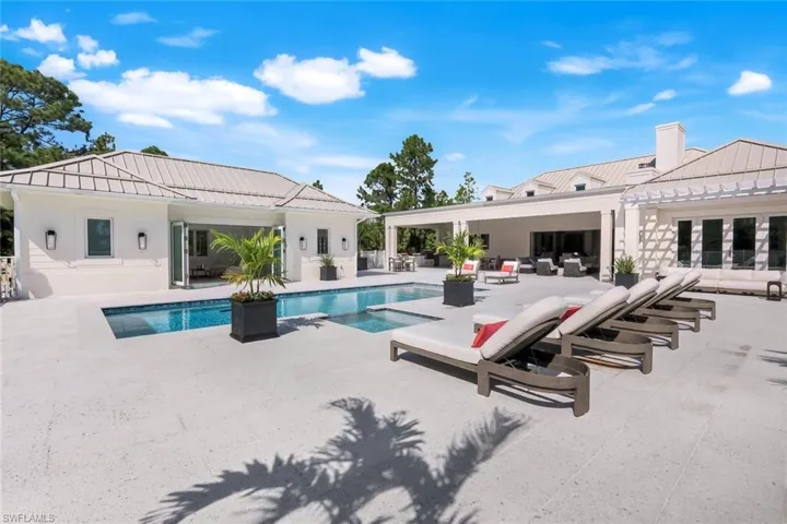 View of swimming pool with a patio, an outdoor living space, and a pool with connected hot tub