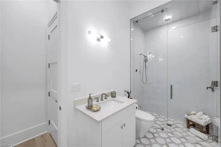Full bath featuring vanity and a stall shower
