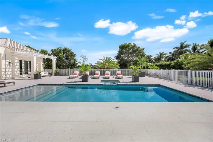 View of swimming pool with a patio, french doors, a fenced backyard, a pergola, and a pool with connected hot tub