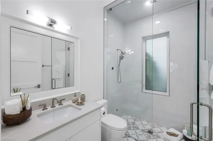 Full bath featuring a stall shower and vanity