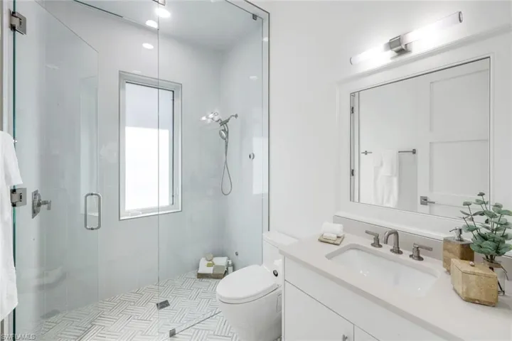 Full bath featuring a shower stall and vanity