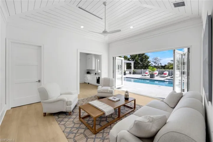 Living room with light wood-style floors, wood ceiling, recessed lighting, and a ceiling fan