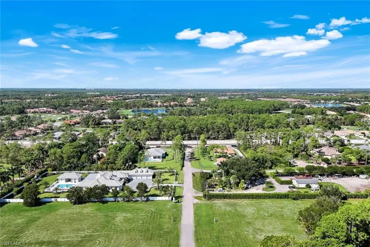Aerial view of property's location featuring nearby suburban area and a nearby body of water