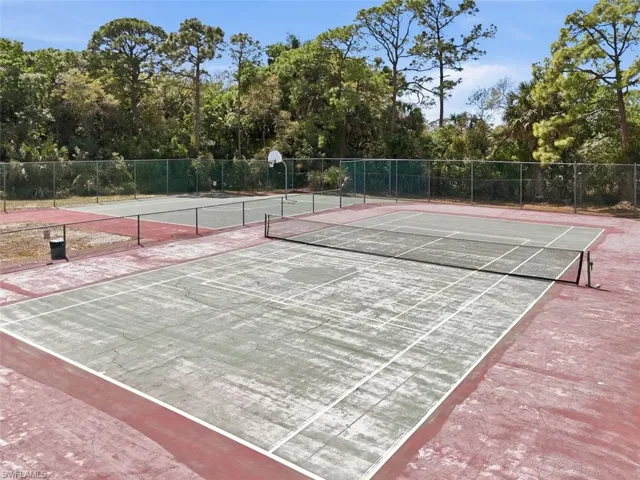 View of tennis court with community basketball court