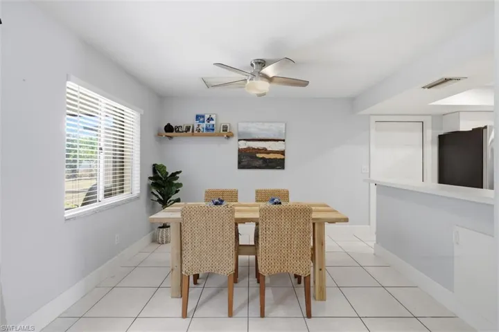 Dining space featuring a ceiling fan and light tile patterned floors