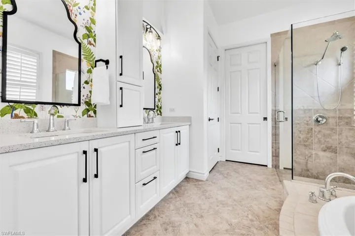 Dual vanity with white cabinetry and integrated sinks, complemented by quartz countertops