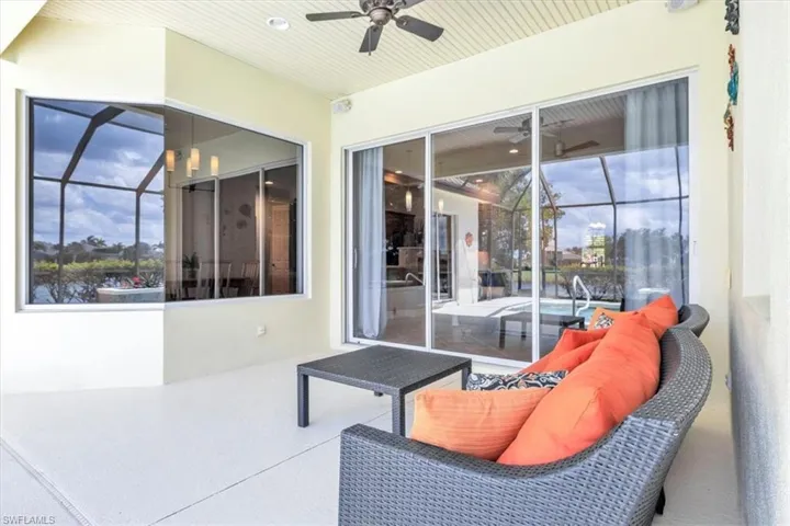 Screened outdoor patio featuring a slatted ceiling, a ceiling fan, and recessed lighting