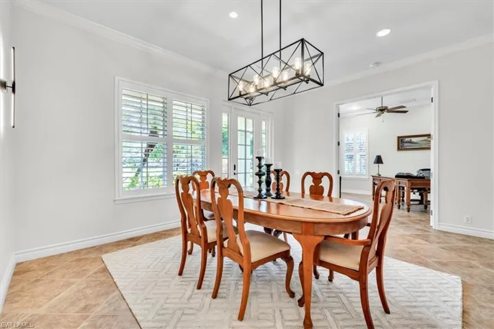 Bright room featuring tile flooring, white walls, and crown molding