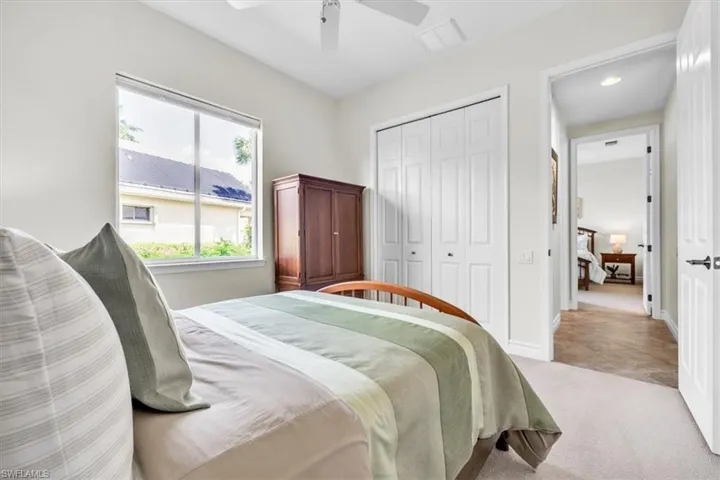 Neutral-toned room featuring a large window, light-colored walls, and carpeting