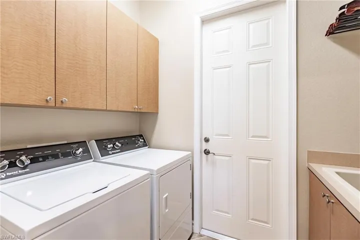 Laundry room with cabinet space and washing machine and dryer