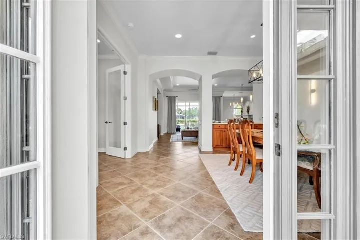 Spacious interior with tile flooring and archway transitions