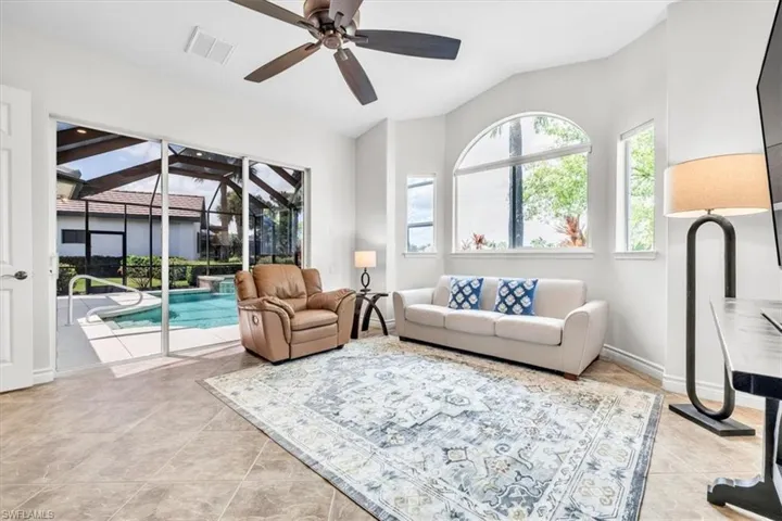Living space featuring large format tile flooring and a ceiling fan