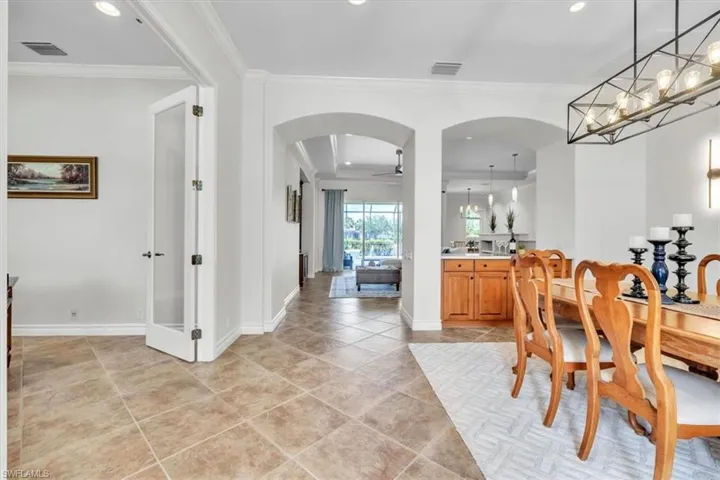 Tiled flooring extending through an arched hallway